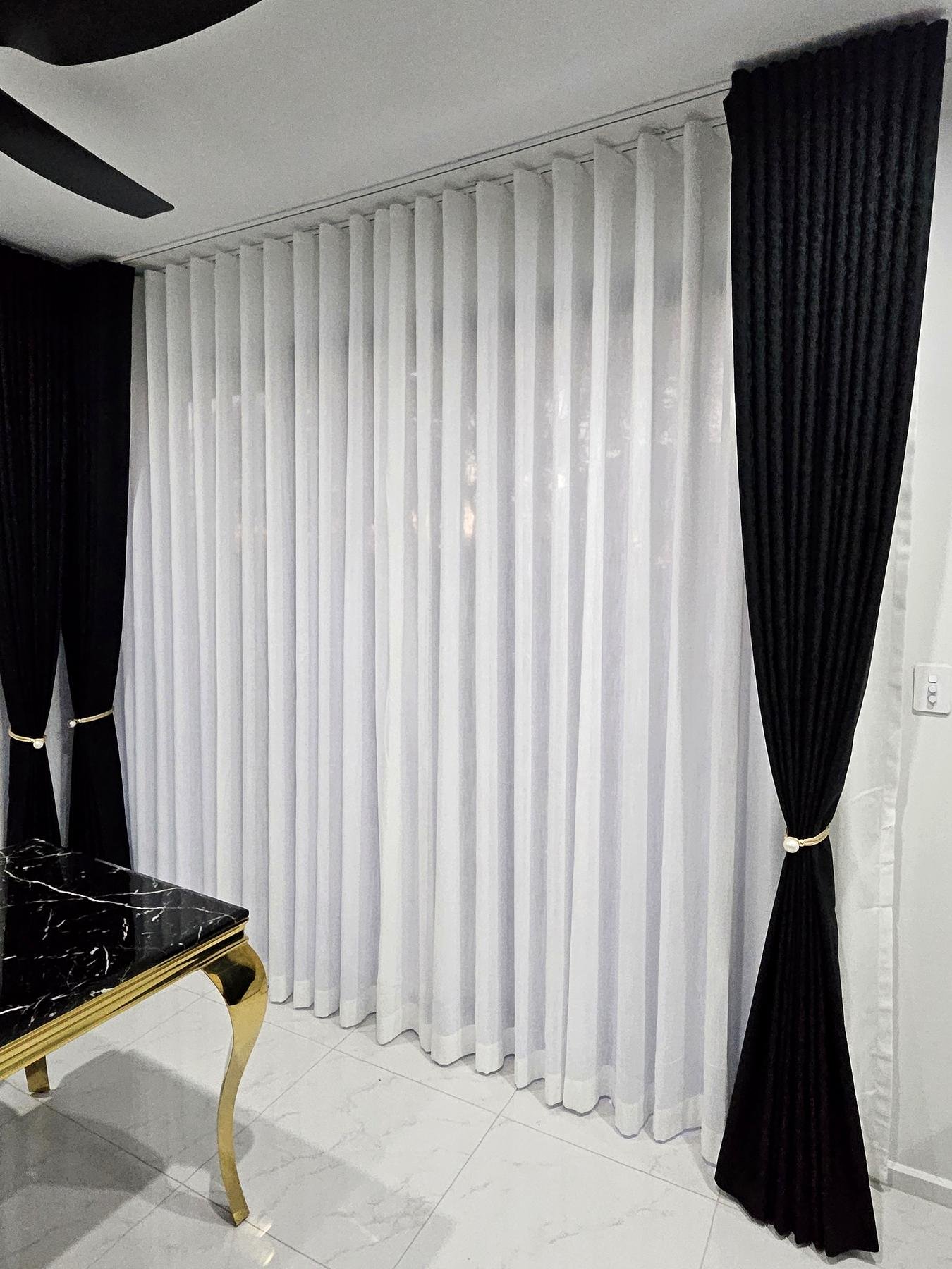 Black blockout curtains and white sheers on a double track