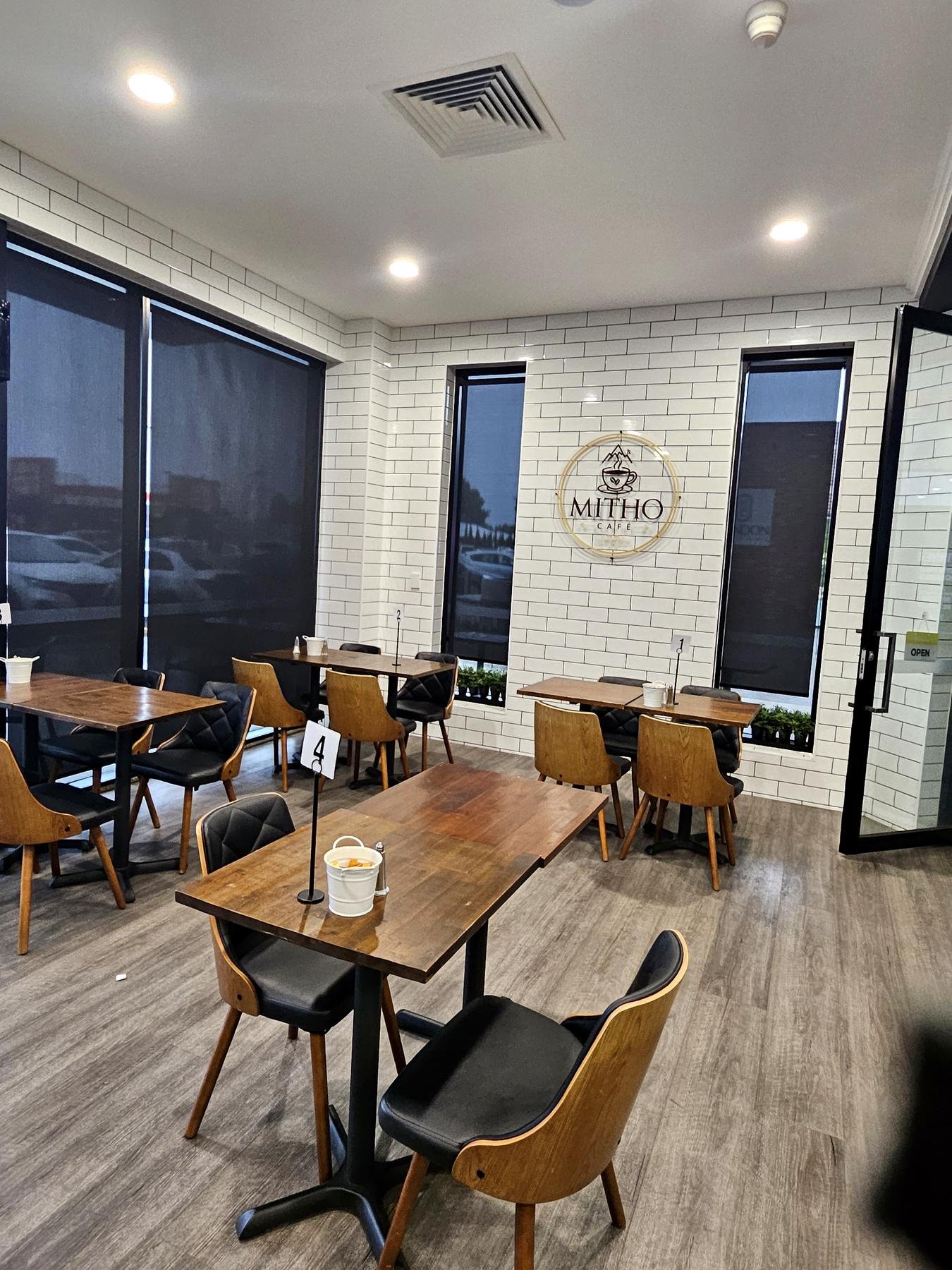 Sunscreen roller blinds on cafe windows