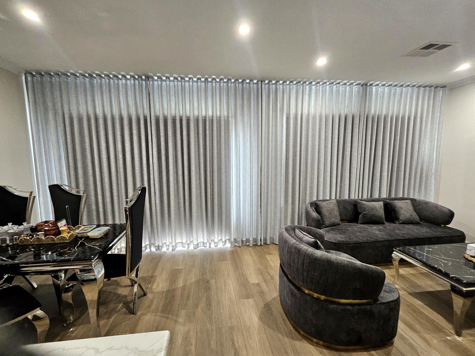 Grey linen-look curtains across a wall of sliding doors