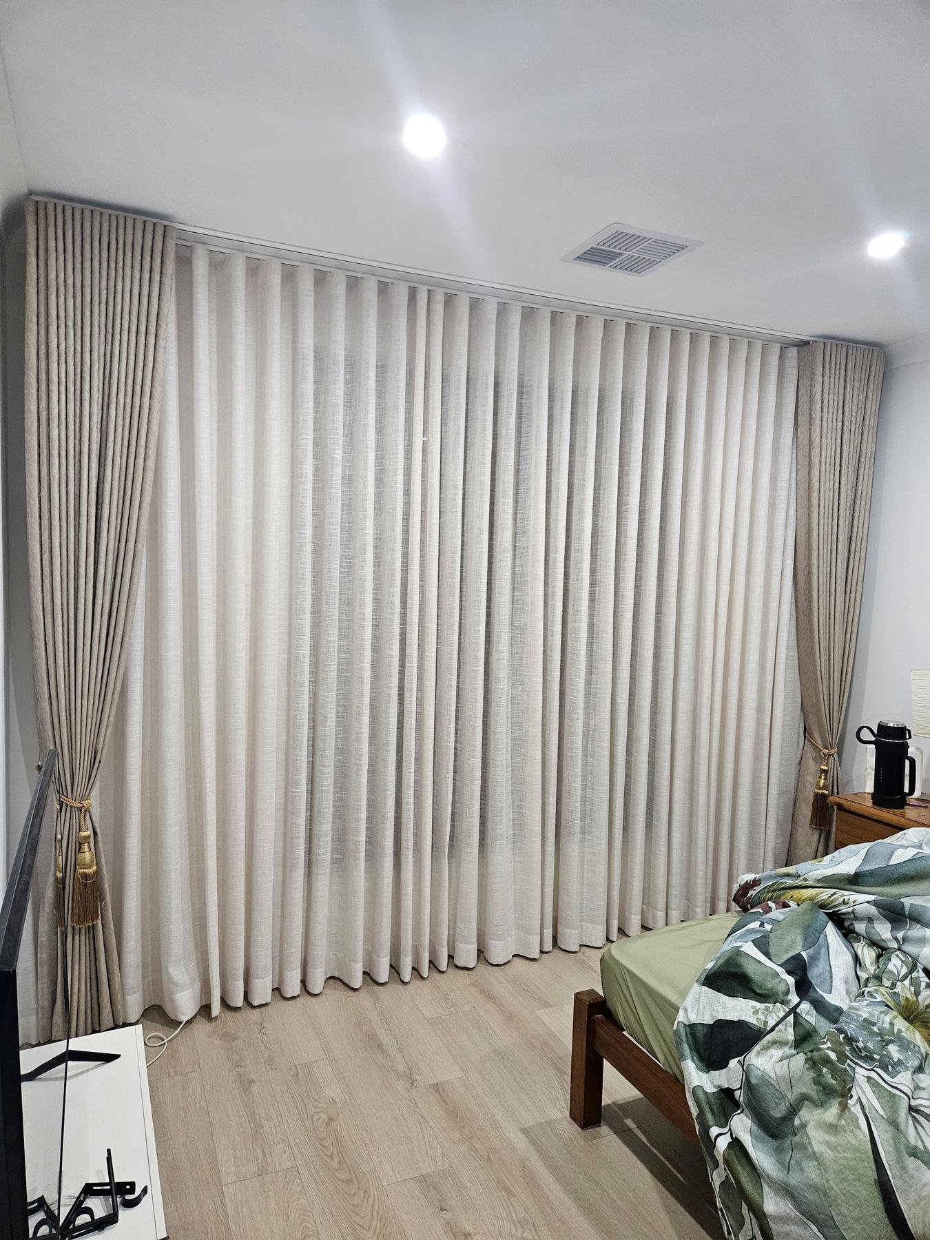 Sheer curtains layered with linen curtains and tiebacks