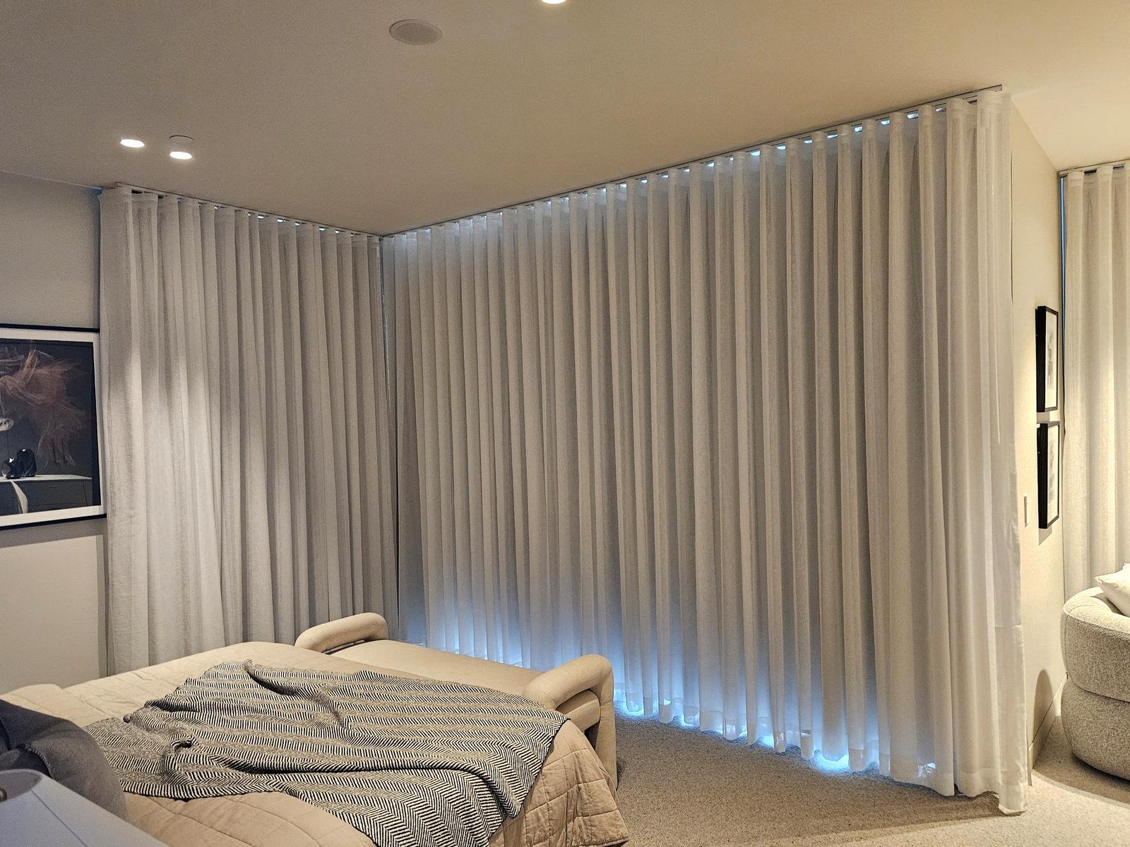 Sheer curtains wrapping the corner of a lounge room