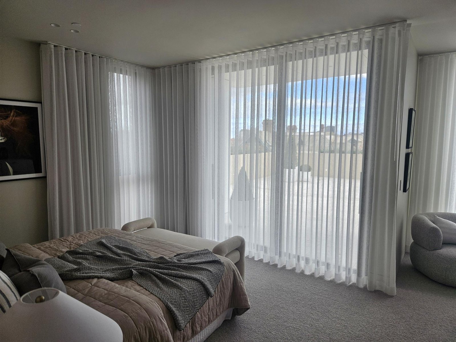 Sheer curtains softening light in a master bedroom